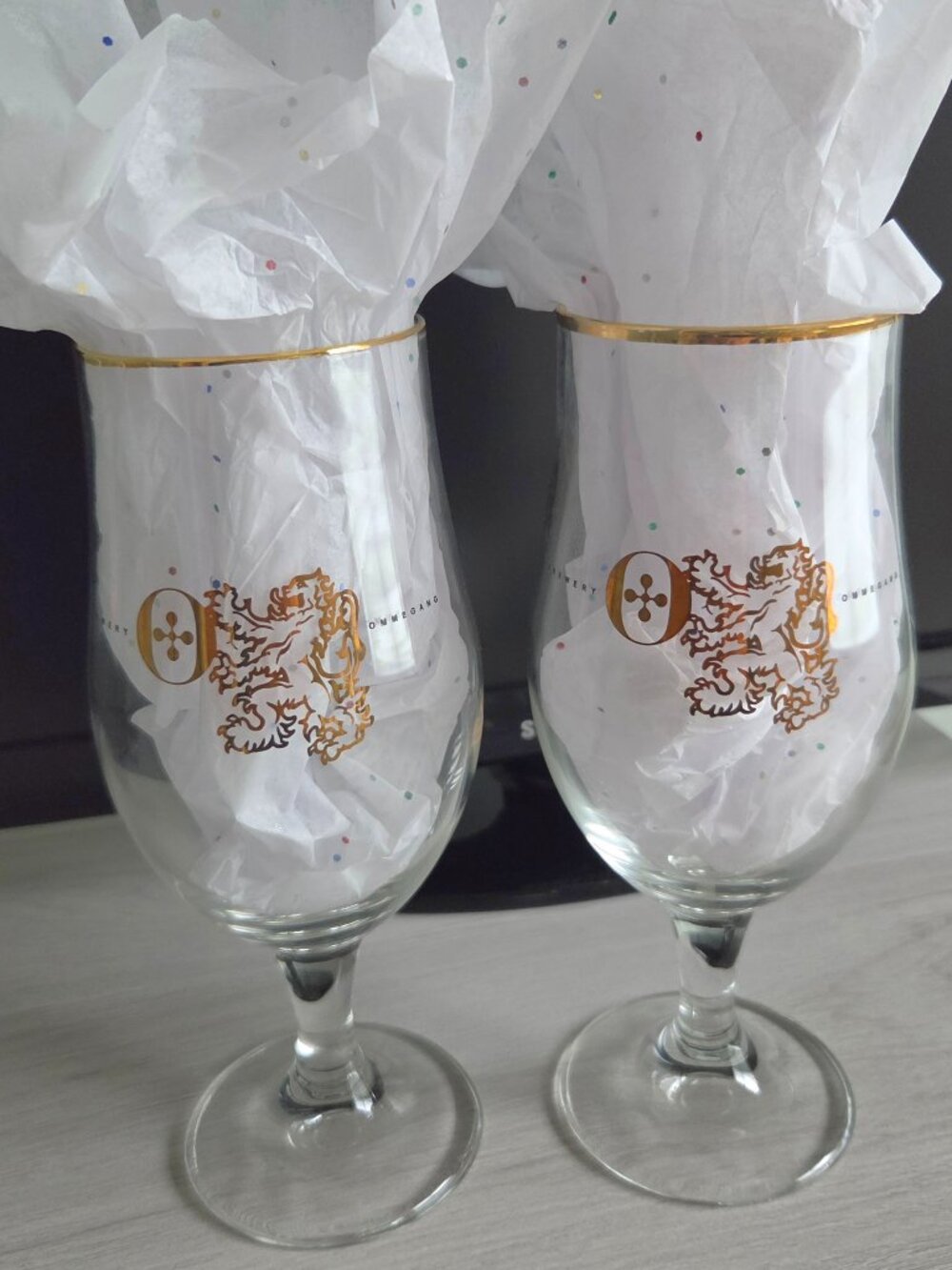 BEER GLASSES, TWO OMMEGANG GOLD LION LOGO AND GOLD RIM COLLECTOR GLASSES